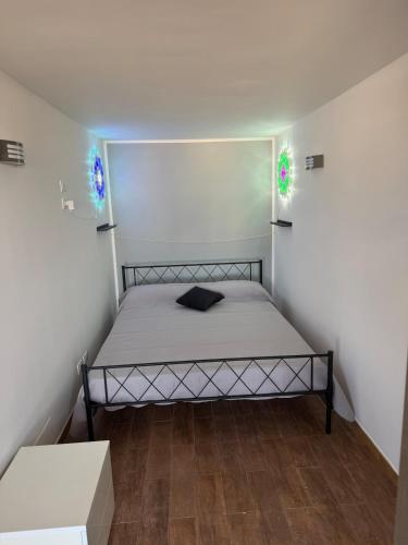 a small bedroom with a bed in a room at Illumina House 3 in Giurdignano