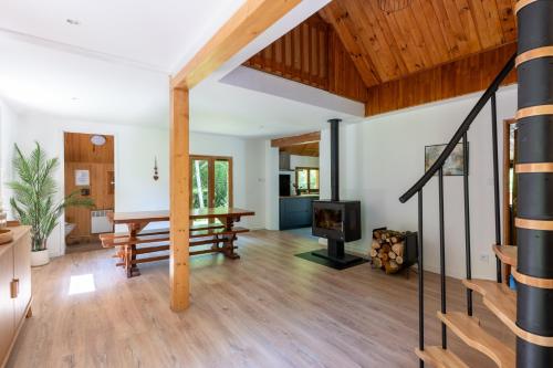 an open living room with a table and a tv at Chalet du Lacus in Boutx