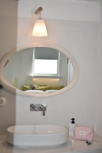 a bathroom with a sink and a mirror at Thronos in Vlychada