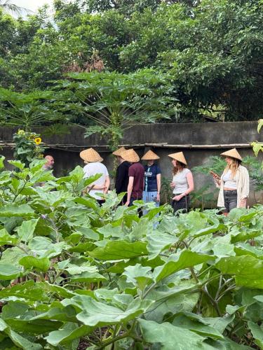a group of people wearing hats standing in a garden at Daphne Homestay & Cooking Class in Senggigi
