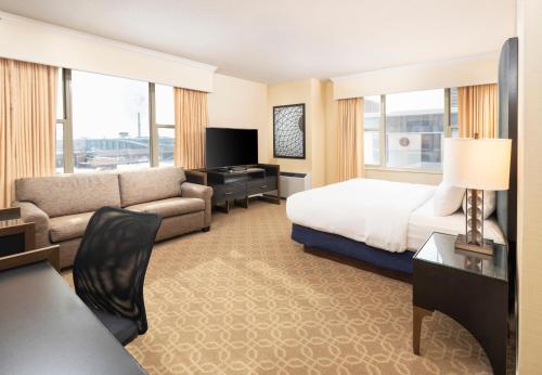 a hotel room with a bed and a couch at The Marc Hotel in Milwaukee