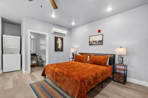 a bedroom with a bed with an orange bedspread at #7 Studio Town Place 2 in Sevierville