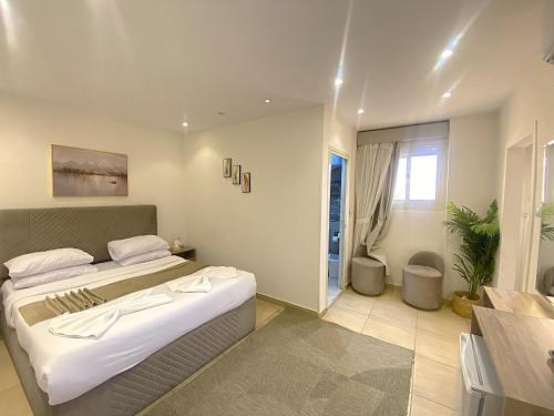 a bedroom with a large bed and a table at Seven Pyramids View Inn - Rooftop Breakfast in Cairo