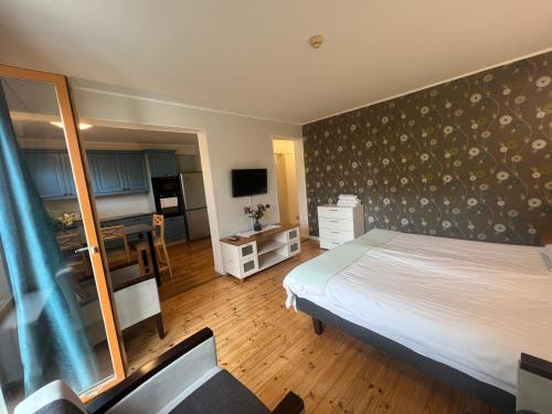 a bedroom with a bed and a desk in it at Villa Meri Apartments in Pärnu