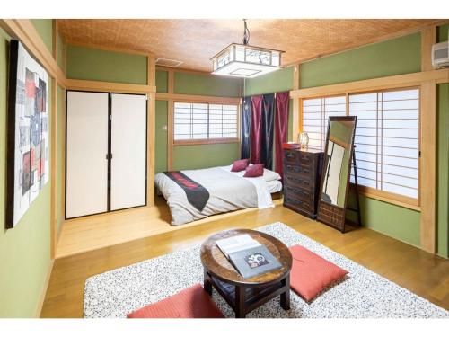 a bedroom with a bed and a mirror and a table at THINK - Vacation STAY 30630v in Ichigaya