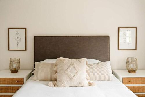 a bedroom with a large bed with two night stands at Airy 3BD Cottage Yard Grill & Steps to Beach in Folly Beach
