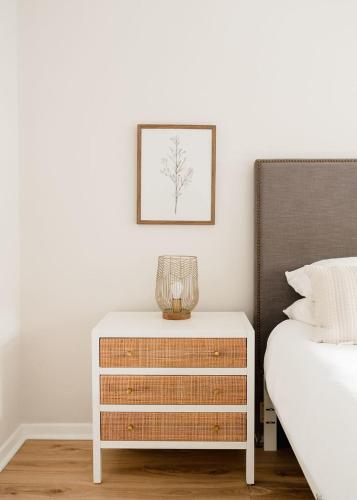 a bedroom with a dresser next to a bed at Airy 3BD Cottage Yard Grill & Steps to Beach in Folly Beach