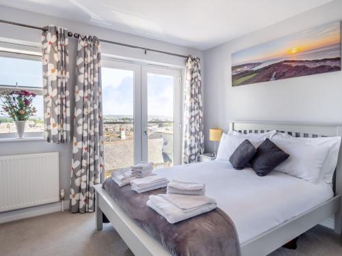 a bedroom with a bed and a large window at 3 Bed in Shanklin oc-ic180 in Shanklin