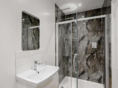 a white bathroom with a sink and a shower at 2 Bed in Harrogate oc-hh018 in Lindley