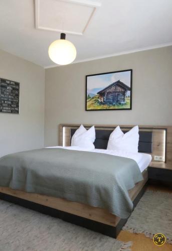 a bedroom with a large bed with white pillows at Ferienhaus Ströbl in Liesing