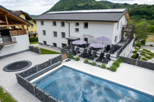 an aerial view of a house with a swimming pool at VILA LISJAK - Apartments in Podčetrtek