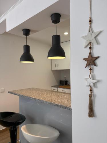 a kitchen with two black lights and stars on the wall at Namaste in Sesimbra