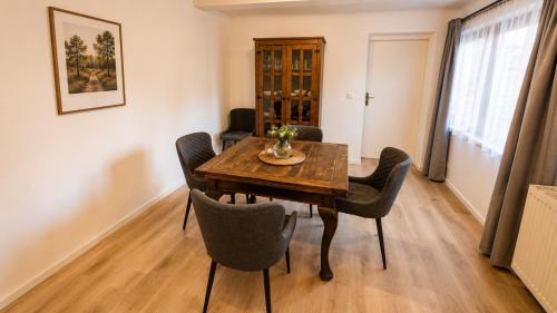 a dining room with a wooden table and chairs at Ferienwohnung Hoffmann in Radebeul