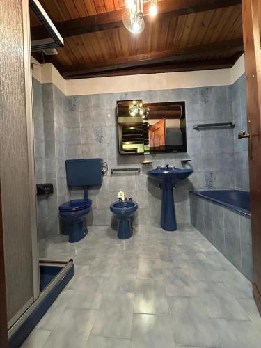 a bathroom with two toilets and a sink and a mirror at La meison de Rita in Pré-Saint-Didier