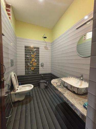 a bathroom with a tub and a toilet and a sink at The Luxora Villa in Kuilapayam