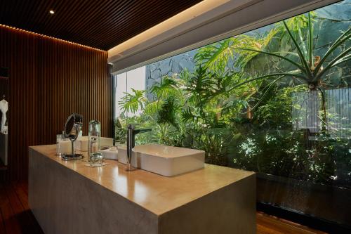 a bathroom with a sink and a large window at Casa Carmen Xólotl in Oaxaca City