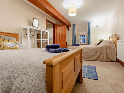 a bedroom with two beds and a dresser at 3 Bed in Bala oc-52810 in Llanuwchllyn