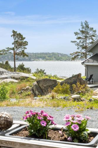 a view of a house with flowers in a window at Seaside Escape - 10 Min to Ocean in Ytre Søndeled
