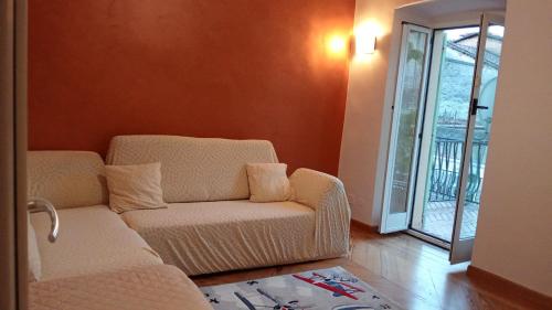 a living room with a couch and a chair at La pergola in Sagliano Micca