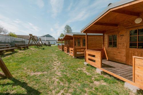 a row of wooden cabins in a yard at U Bernarda in Slavíkovice