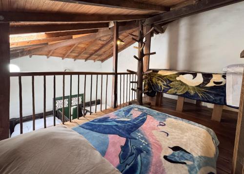 a bedroom with a bed and a balcony at Finca Campestre La Adelita B&B in Salento