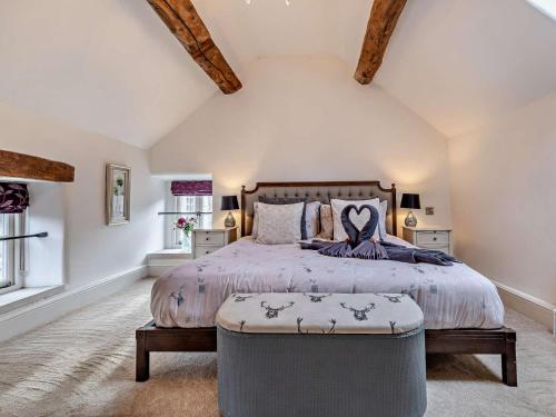 a bedroom with a large bed and an ottoman at 1 Bed in Matlock oc-75400 in Middleton