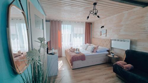 a small bedroom with a bed and a mirror at Apartamenty Perła Bałtyku in Władysławowo