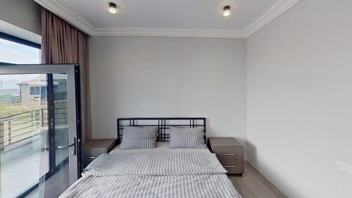 two beds in a white room with a window at Mughni home in Ashtarak