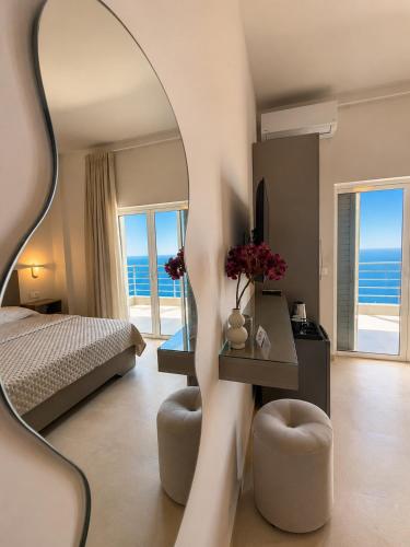 a bedroom with a bed and a mirror at Nostos Palase in Dhërmi