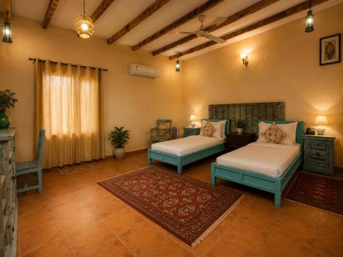 a living room with two beds and a couch at WelcomHeritage Ranjitvilas in Amritsar