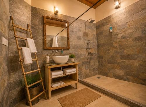 a bathroom with a sink and a mirror at WelcomHeritage Ranjitvilas in Amritsar