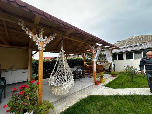 a man walking through a patio with a hammock at Casa Enka in Tuzla
