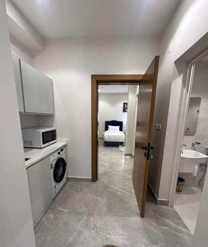 a bathroom with a sink and a bed in a room at فندق كتيفا نورث in Arar