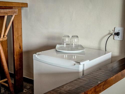 a white table with two glasses on top of it at Sofia's on the Beach in Búzios