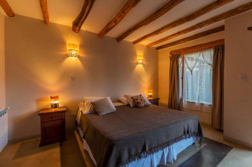 a bedroom with a large bed and a window at KALLPA WARMI Hotel Panoramico in Tilcara