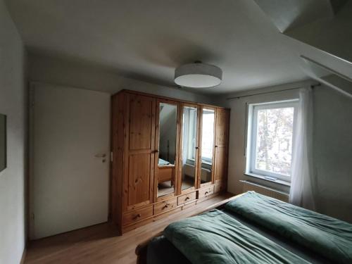 a bedroom with a bed and a large window at Harbour Apartment in Moos