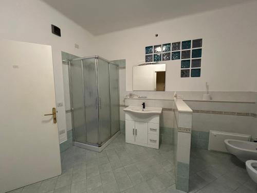 a bathroom with a shower and a sink and a toilet at Affittacamere VITRUVIO in Fano