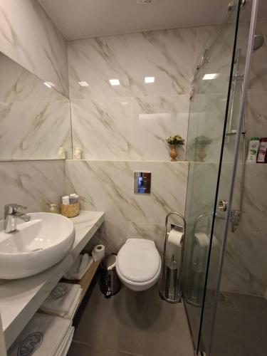 a bathroom with a shower and a toilet and a sink at Railway Studio 1 - Cozy Studio in Byblos - Central Location in Jbeil