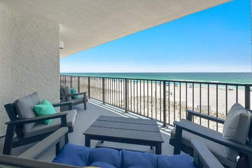 a balcony with chairs and a view of the beach at Lei Lani Unit 201T in Orange Beach