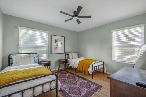 a bedroom with two beds and a ceiling fan at Welcome To Riverside - Spacious, Cozy, Central in Riverside