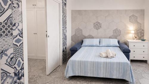 a bedroom with a bed with a stuffed animal on it at Domus Valeria - Suite Boutique Centro Storico Murales Odissea in Sperlonga