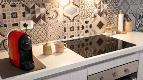 a coffee maker sitting on a counter in a kitchen at Domus Valeria - Suite Boutique Centro Storico Murales Odissea in Sperlonga