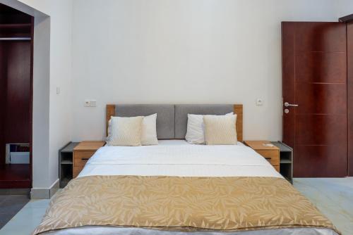 a bedroom with a large bed with two night stands at Mandela Suite, Ngor Almadies, Dakar, Senegal Appart 2 chambres, 2 salles de bain in Dakar