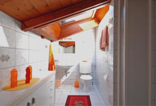 a bathroom with a toilet and a sink at Casa Esmeralda in San Nazzaro