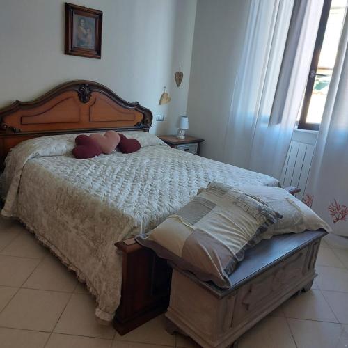 a bedroom with a bed with red pillows on it at CasaEma in Torre del Lago Puccini