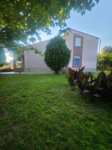 a house with a green lawn in front of it at paralia ofriniou beautiful house in Karianí