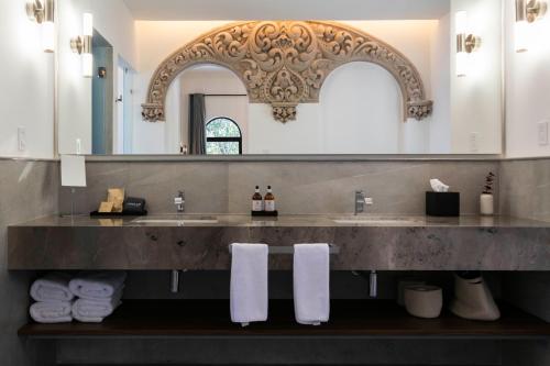 a bathroom with two sinks and a large mirror at Casa Lerma in Mexico City