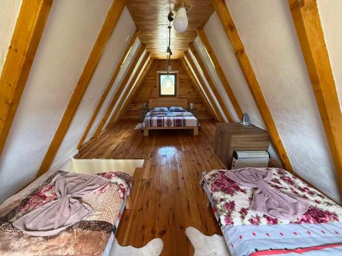 a room with two beds in a attic at Bungalovi 3AS in Žabljak