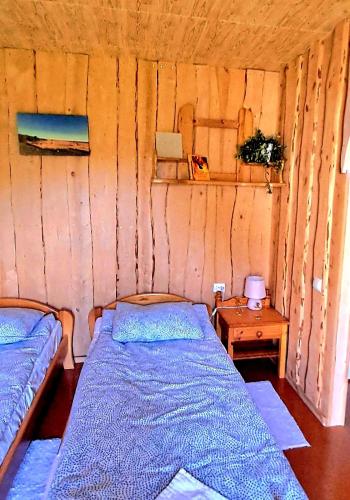 a room with two beds and a table in it at Imantass in Salacgrīva