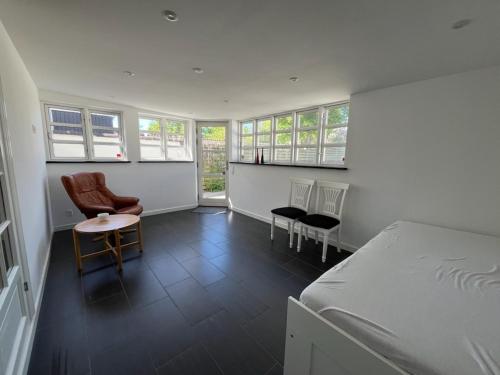 a bedroom with a bed and a table and chairs at Møllevej in Hjørring